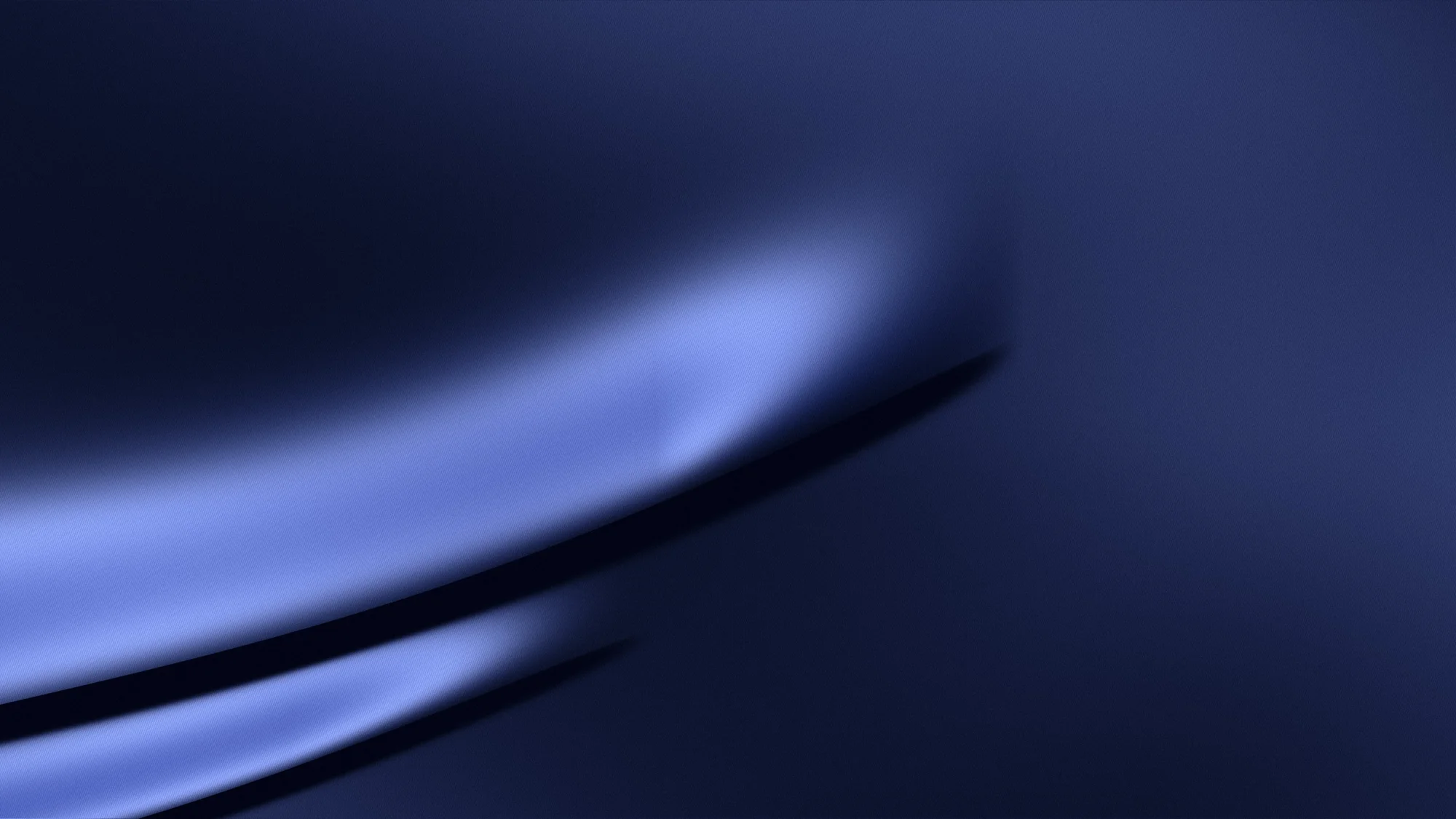 Sapphire Silk: Sapphire satin entering from the left edge: one large fold with a crisp crest, a smaller fold beneath it, and a satin sheen running along the weave.