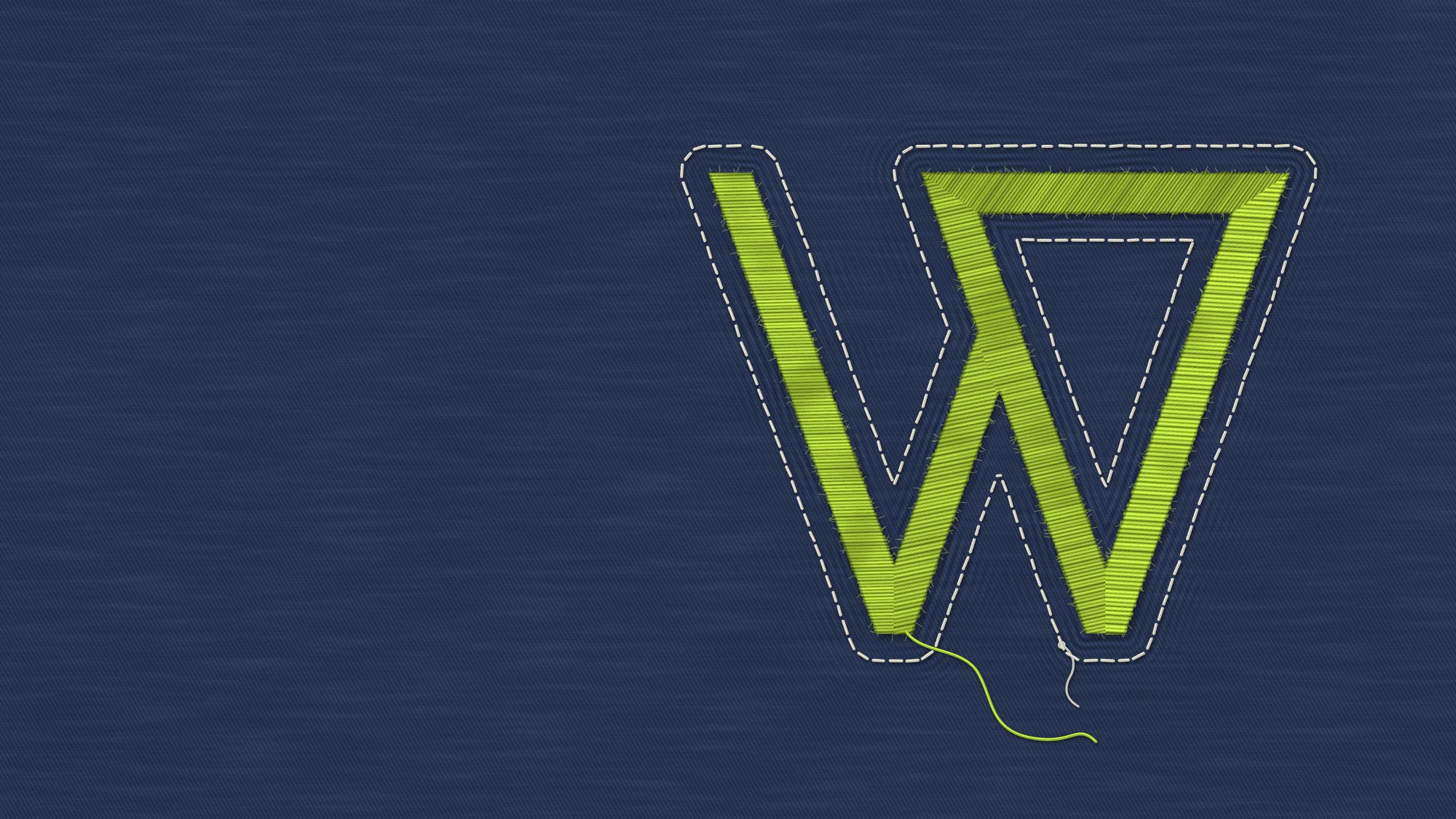 Embroidered W: The W embroidered in lime satin stitch on indigo denim twill: each stroke stitched at its own angle and density, the fabric puckered around it, an off-white running stitch tied off by hand and one loose thread left trailing.
