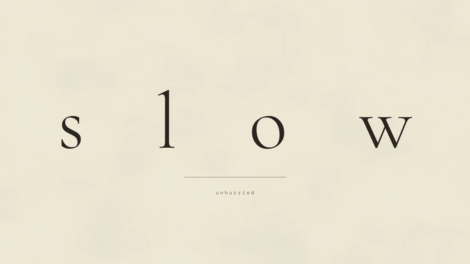 Slow (desktop): The word slow set with extreme letter-spacing on cream paper.